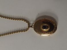9 carat gold locket with central amethyst on a 9 c