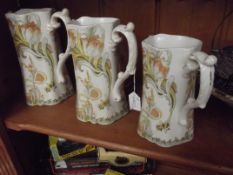 3 graduating water jugs