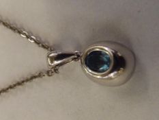 9 carat white gold pendant set with blue Topaz and