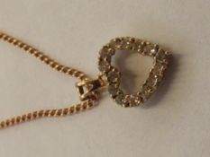 9 carat gold heart shaped pendant set with white g