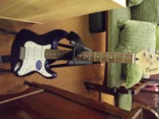 Squier electric guitar with stand