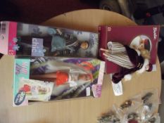 Three boxed Barbie dolls