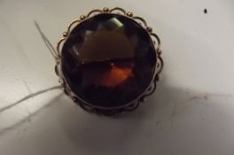 9 ct gold brooch with a large yellow stone