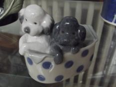 Nao figure of two puppies in a basket