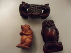 Three carved wooden netsukes