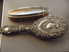 Silver repoussé hair brush together with a silver