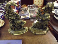Pair of brass doorstops in the form of Punch and J