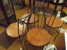 Set of four wrought iron chairs with wooden seats