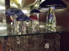 Four iridescent glass mushrooms