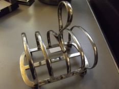 Silver hallmarked four division toast rack on ball