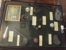 Cased reproduction golf balls and gold clubs