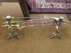 Pair of brass fire dogs together with a three piec