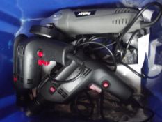 Two power drills together with an angle grinder, working