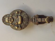 Brass Oriental Buddha hook, signed