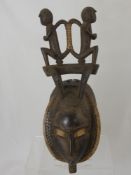 A West African (Cote d' Ivoire) Yaoure Funeral Mask, this oval mask depicts two monkeys (to