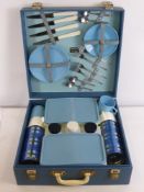 A Vintage Sirram Picnic Set, complete with four cups, four saucers, four plates, two sandwich boxes,