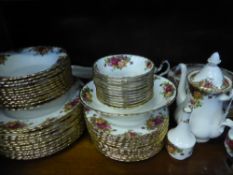 A Royal Albert 'Country Roses' Dinner Service, comprising twelve dinner plates, fourteen fish