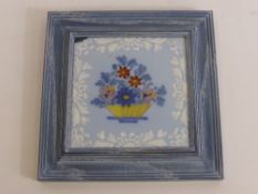 A Framed Bristol Tile 1760/70, depicting a basket of flowers.
