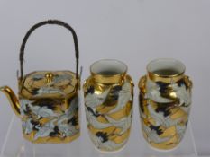 A Japanese Tea Pot and two Vases, the tea pot having a wire handle depicting cranes. The vases