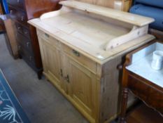 An Antique Pine Side Board, with two cupboards and two drawers beneath a galleried surface, approx