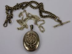 An Antique Silver Locket, having initials in the form of branches to the front together with a solid