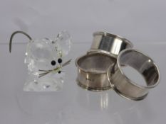 A Swarovski Crystal and Silver Metal Mouse, together with three silver napkin rings, London