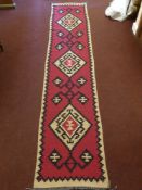 A 20th Century Turkish Tekke Woollen Kilim, of geometric design, maroon, beige and black runner,