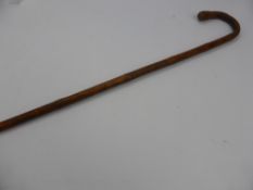 An Antique Japanese Bamboo Walking Stick, depicting a character with a fan, bird of prey and monkey,