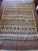 A 20th Century Tribal Rug, with stripes and geometric design in pink, blue and green, with floral