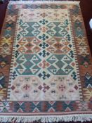 A 20th Century Turkish Woollen Kilim Rug, of geometric design in dark pink, pale pink and green,