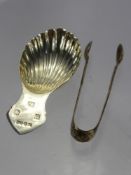 A Silver Caddy Spoon, Birmingham hallmark dd 1982, mm A.M. & Co., together with a pair of sugar nips