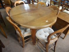 An Edwardian Solid Oak Wind Out Oval Dining Table, on tapered legs and casters, approx 135 x 100 x