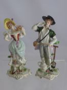 A Pair of Sitzendorf Figurines, depicting a boy and girl, factory marks to base, approx 20 cms high.