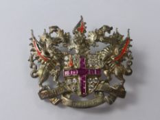 A Silver Heraldic CZ's and Pink Enamel Brooch, the brooch depicting dragons with Latin motto 