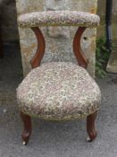 A Fruit Wood Bedroom Chair, of unusual design on porcelain casters.