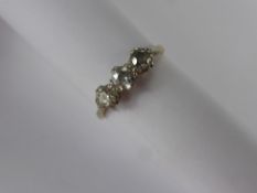 A Lady's 18 ct Yellow Gold and Platinum Three Stone Diamond Ring, size O, 1 x 25 pt dia, 2 x 18 pt