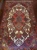 A Contemporary Iranian Woollen Rug, floral design, jewel colours on cream ground, approx 220 x 130