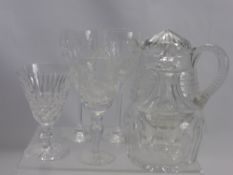 A Miscellaneous Collection of Cut Glass, including wine glasses, water jug and three decanters.