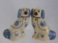 A Pair of Antique Porcelain Blue and White Staffordshire Spaniels, approx 30 cms high. (2)