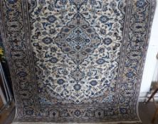 A Contemporary 'Kashan' Persian Rug, blue medallion design on cream ground, approx 250 x 170 cms