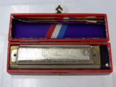 A M. Hohner Superchromonica Harmonica in the original box.