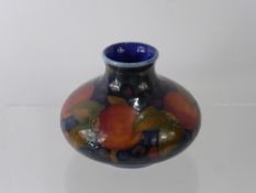 William Moorcroft 'Pomegranate' Vase, the vase of squat form, on green blue ground, factory marks to
