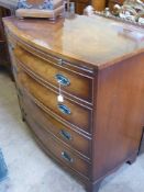 A Georgian Style Bow Fronted Mahogany Inlaid Chest of Drawers, the chest having four graduated