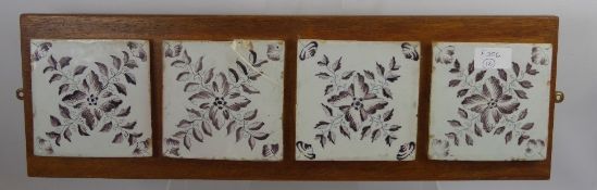 Four Antique Delft Tiles, mounted on an oak plinth, approx 57 x 18 cms.