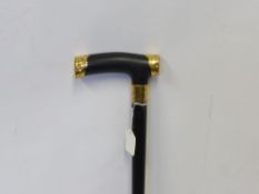 An Early 20th Century Gold Capped Ebony Walking Stick, makers mark J. Howell & Co Ltd, 1910-1916,
