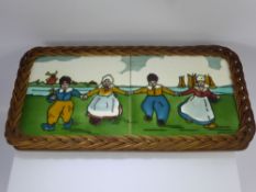 Two Vintage Dutch Ceramic Tiles, depicting characters dancing, the tiles set in a wicker frame,