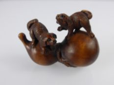 A Japanese Netsuke, in the form of a double gourd carved with puppies, approx 5 cms, character marks