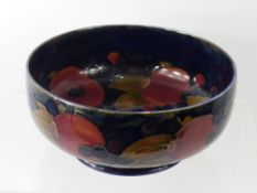 William Moorcroft 'Pomegranate' Fruit Bowl, of circular form, on green blue ground, factory marks to