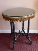 A Black Lacquer Round Occasional Table, celadon green silk top, on tripod base.