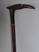 An Antique Mixed Wood Cane, the carved horn handle in the form of a crane.
